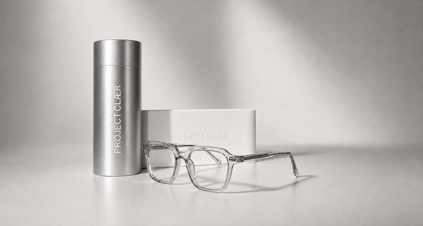 PROJECT CLAER clear blue light glasses with a cylindrical container and box on a light gray background
