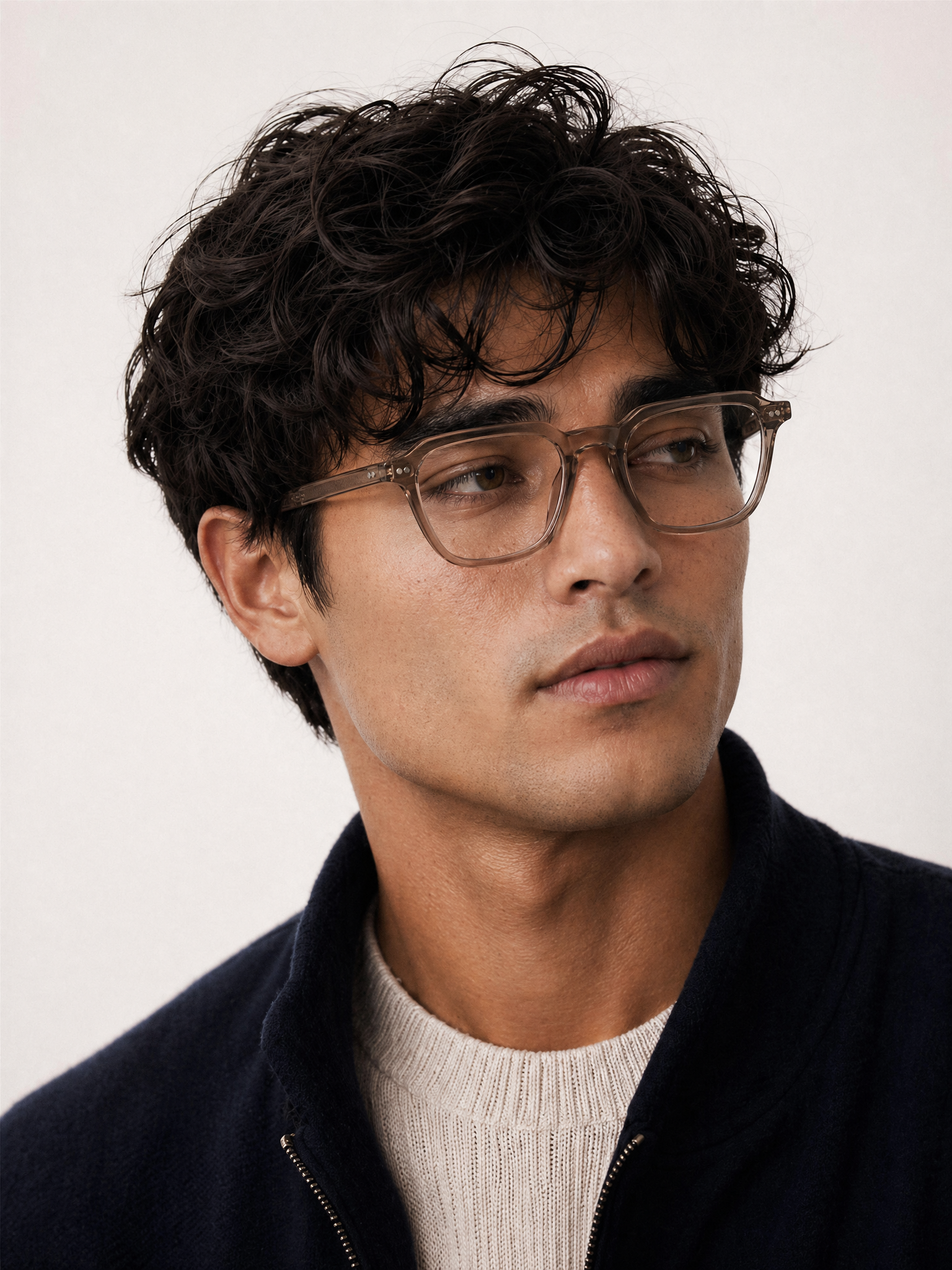 Man wearing blue light glasses with a neutral background